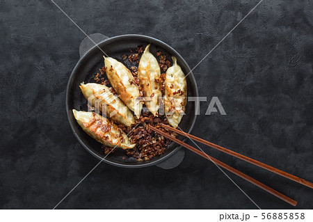 Fried Asian dumplings in bowl 56885858