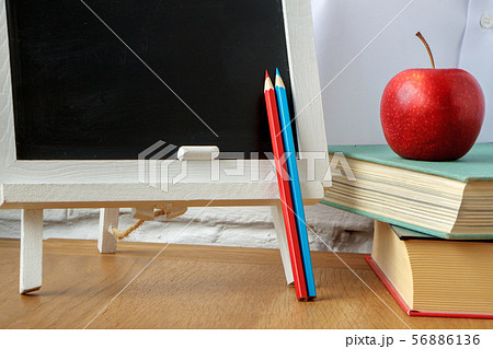 School supplies, miniature chalk board, a stack of School supplies, miniature chalk board, a stack of 56886136