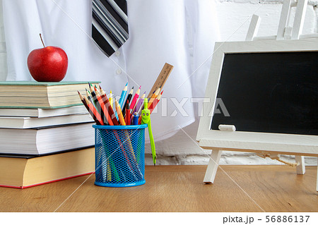 School supplies, miniature chalk board, a stack of School supplies, miniature chalk board, a stack of 56886137