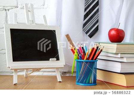 School supplies, miniature chalk board, a stack of 56886322