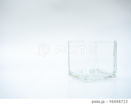 empty glass container in light grey background 56898713