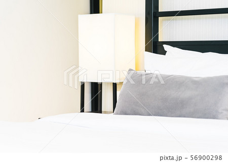 Beautiful luxury comfortable pillow on bed with light lamp Beautiful luxury comfortable pillow on bed with light lamp 56900298