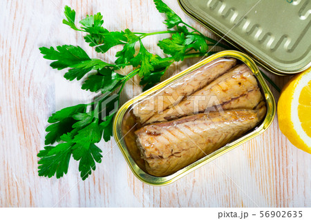 Tasty fillet of mackerel in sunflower oil with greens and lemon 56902635