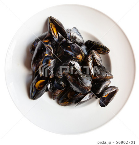 Delicious grilled mussels on plate, served with ali-oli sauce Delicious grilled mussels on plate, served with ali-oli sauce 56902701