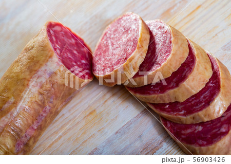 Salchichon spanish sausage slices on wooden desk Salchichon spanish sausage slices on wooden desk 56903426