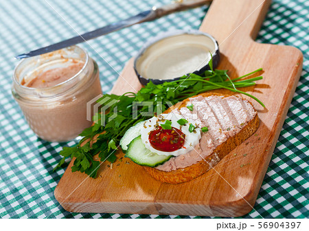 Toasted bread with rillettes and fresh cheese on wooden board Toasted bread with rillettes and fresh cheese on wooden board 56904397