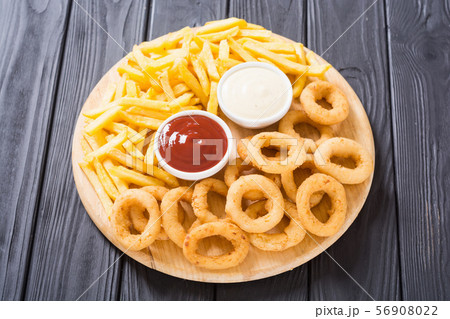 French fries and onion rings with sauces 56908022