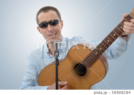 man with an acoustic guitar in his hands 56908284