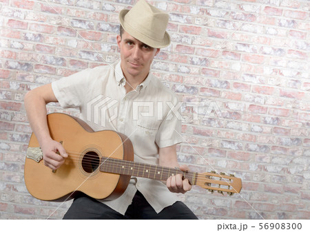 man with an acoustic guitar in his hands man with an acoustic guitar in his hands 56908300