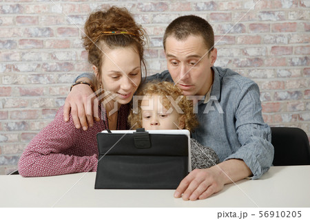 happy family playing with a tablet computer 56910205