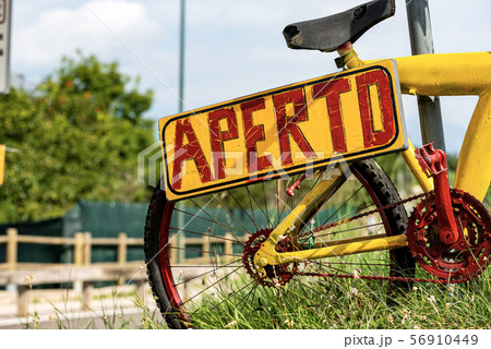 Aperto - Open Sign in Italian Language on an old bicycle 56910449