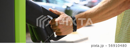 Male hand hold pistol an electric charge Male hand hold pistol an electric charge 56910480