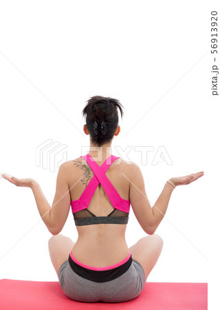 sporty woman practicing yoga lotus pose, back view 56913920