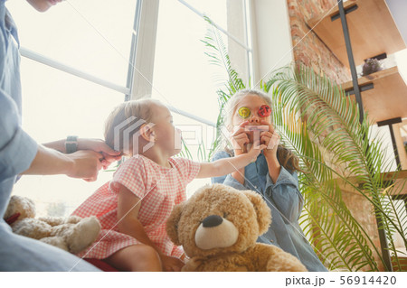 Young mother and her daughters moved to a new house or apartment Young mother and her daughters moved to a new house or apartment 56914420