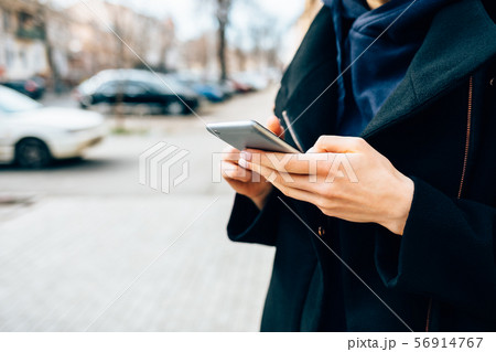 Close-up young woman wearing elegant black coat Close-up young woman wearing elegant black coat 56914767