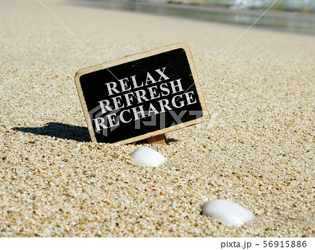 Relax refresh recharge sign on a beach. 56915886