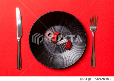 Healthy diet concept of plate with measuring tape, 56920401