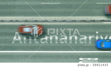 Aerial top down view of the road with cars revealing Antananarivo caption. Car travel in Madagascar 56921435