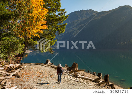 A woman walks along the shore of Baker Lake in North Cascades 56922712