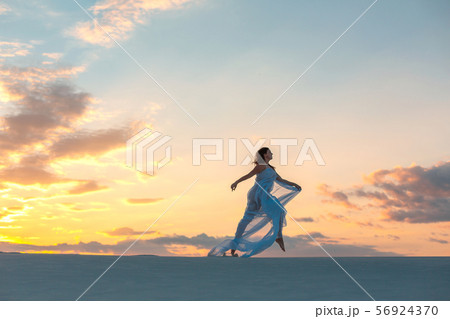 A girl in a fly white dress dances and poses in A girl in a fly white dress dances and poses in 56924370