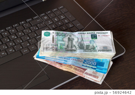 Different banknotes of Russian paper currency on laptop. 56924642