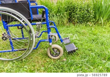 Empty wheelchair standing on grass in hospital Empty wheelchair standing on grass in hospital 56925789