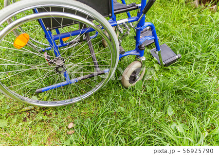 Empty wheelchair standing on grass in hospital Empty wheelchair standing on grass in hospital 56925790