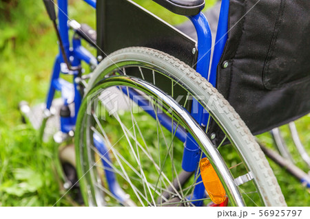 Empty wheelchair standing on grass in hospital 56925797
