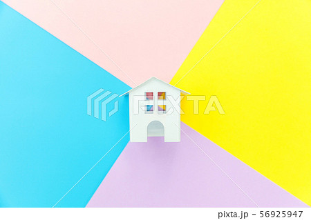 Miniature white toy house isolated on blue yellow 56925947