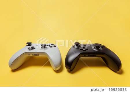 White and black two joystick on yellow background. White and black two joystick on yellow background. 56926058