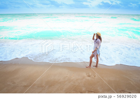 woman on the beach in pink shirt woman on the beach in pink shirt 56929020