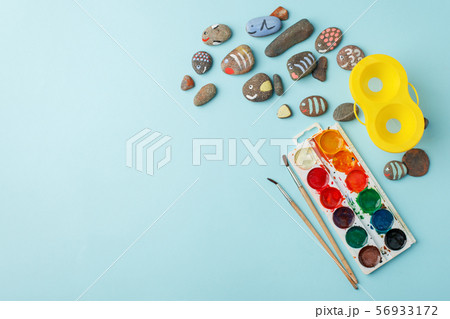 Hand-painted colorful stones and watercolor paint 56933172