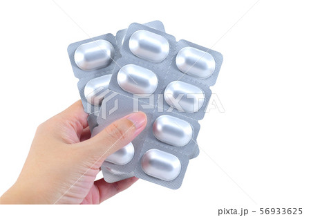 Packs of medicine in hand isolated on white 56933625
