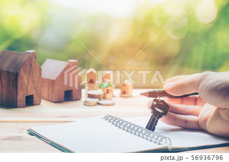 The hand of the man holding the keys and the The hand of the man holding the keys and the 56936796