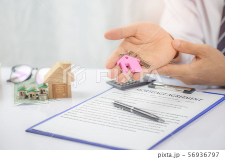 Confident young man hand holding house key,real Confident young man hand holding house key,real 56936797