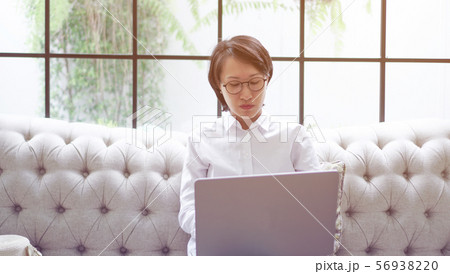 Freelance Asian woman working notebook computer at Freelance Asian woman working notebook computer at 56938220