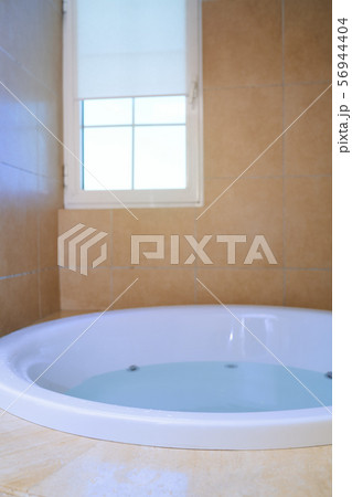 Modern bathroom with bathtube full of water 56944404