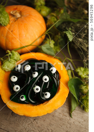 green and black multicolored gummy worms and candies eyes with pumpkin green and black multicolored gummy worms and candies eyes with pumpkin 56945296