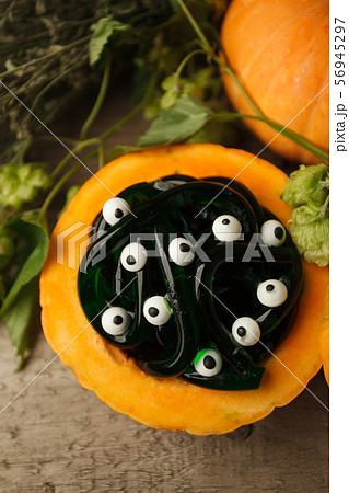 green and black  multicolored gummy worms and candies eyes with pumpkin 56945297