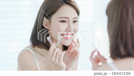 Asian woman with invisible braces Asian woman with invisible braces 56947200
