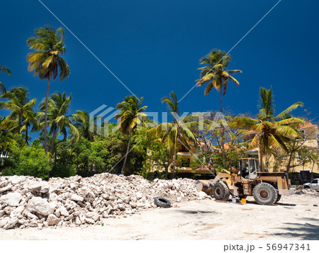 Excavator on construction site with pile of stones 56947341