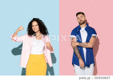 Young emotional man and woman on pink and blue background 56950607