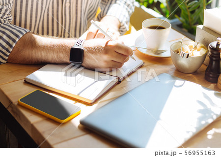Close up of a male hand holding the pen Close up of a male hand holding the pen 56955163