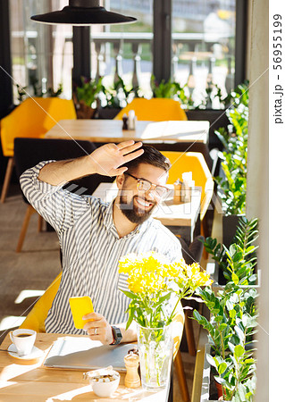 Delighted positive man looking into the window 56955199