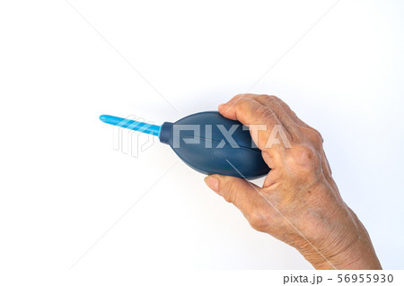 Senior woman's hands squeezing blue blower for cleaning Lens isolated on white background 56955930