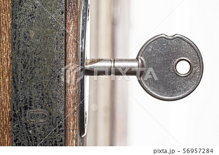 A key for lock or unlock wooden door texture, Close up & Macro shot, Selective focus, Security concept 56957284