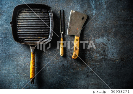 Vintage grill pan butcher and fork on dark Vintage grill pan butcher and fork on dark 56958271