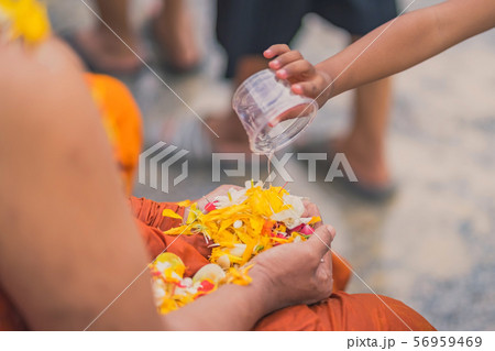 People pouring water to Buddhist Monk and gives blessing in Thailand Songkran annual festival 56959469