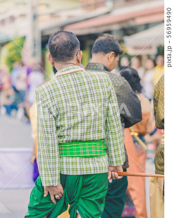 Happiness  villagers dressed in beautiful local costumes join the parade to celebrate Songkran Festival  56959490
