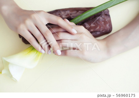 pretty perfect woman hands with white manicure and little flowers on colorful background 56960175